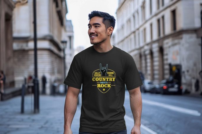Smiling man in a dark T-shirt stands on a city street.